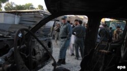 Afghanistan security forces inspect the scene of an attack on the Afghan Police headquarters in Jalalabad on June 1 .