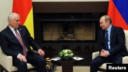 Russian President Vladimir Putin (right) speaks during a meeting with Leonid Tibilov, the de facto leader of the Georgian breakaway region of South Ossetia in Moscow late last month.