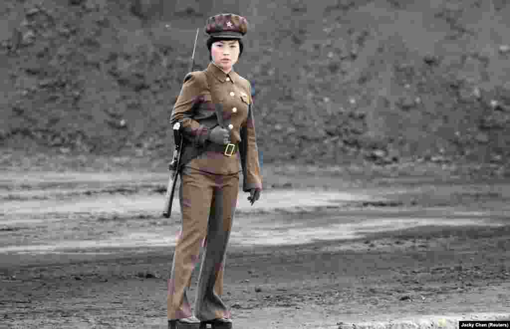 A female North Korean soldier stands guard along the banks of the Yalu River, near the town of Sinuiju, opposite the Chinese border city of Dandong. (Reuters/Jacky Chen)