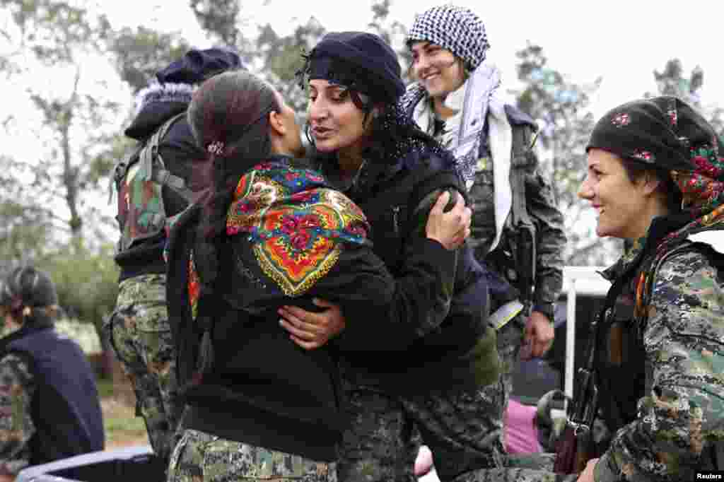 A fighter from the Kurdish People's Protection Units (YPG) hugs a fellow fighter in a YPG military base east of Qamishli before heading to the front lines in Syria. (Reuters/Massoud Mohammed)