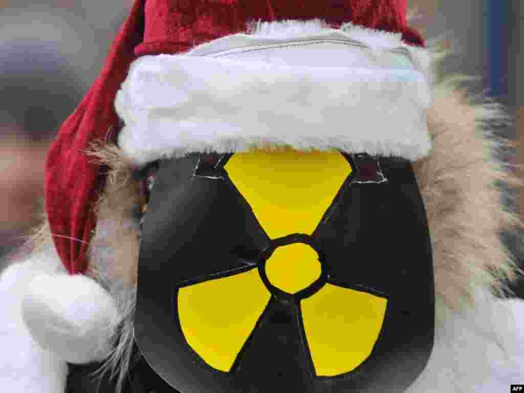 A Ukrainian Green Party activist looks on during a demonstration in Kyiv. - A demonstration was held in Kyiv on December 17 outside the Ukrainian parliament building against a bill proposing the construction of a radioactive waste dump in the Kyiv region. Photo by Sergei Sopinsky for AFP