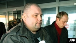 Russian citizen Yury Mel (left) is brought to the district court in Vilnius on March 14.