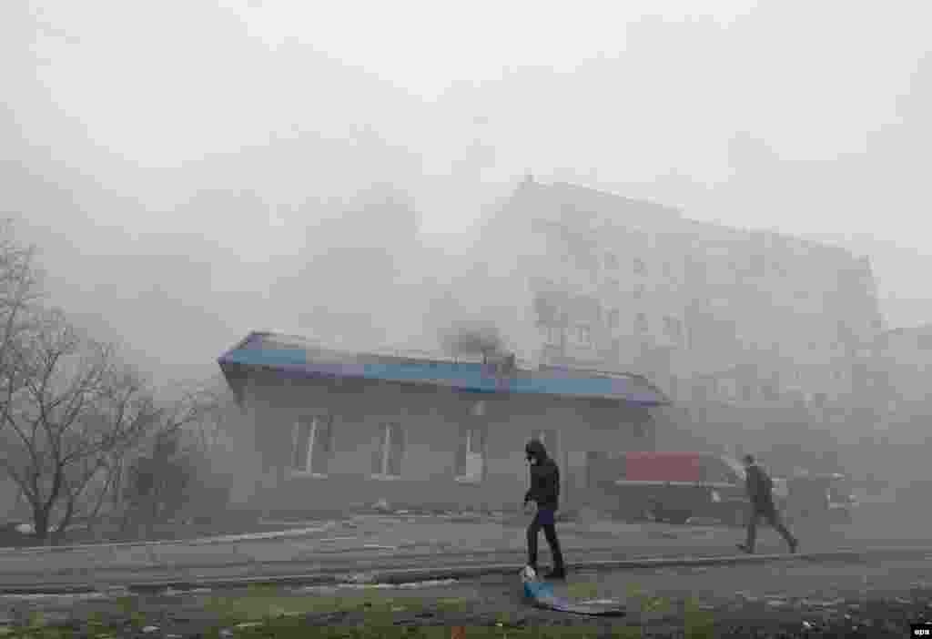 Smoke billows from residential buildings in Mariupol after the city was hit by shelling.