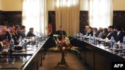 Which other ministers might Afghan President Hamid Karzai (center, presiding over a cabinet meeting) be forced to sacrifice?