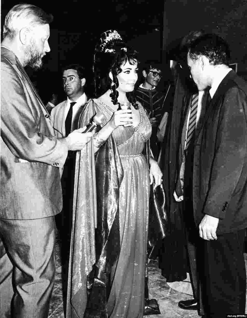 Elizabeth Taylor takes a break for an interview with Radio Free Europe in 1962 on the set of the epic film Cleopatra. - Elizabeth Taylor takes a break for an interview with Radio Free Europe in 1962 on the set of the epic film Cleopatra.