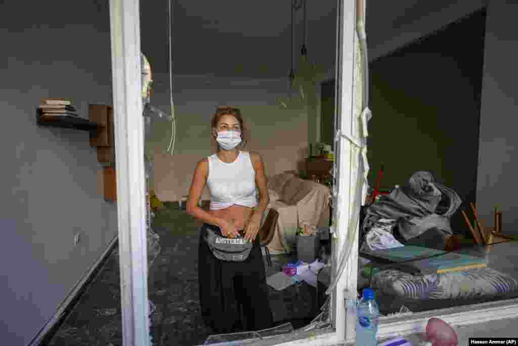 Sandrine Zeinoun, 34, poses for a photograph inside her destroyed apartment after Tuesday&#39;s explosion in the seaport of Beirut, Lebanon, Thursday, Aug. 6, 2020.