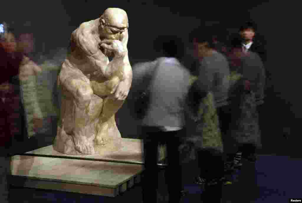 Visitors to the National Museum of China in Beijing look at the sculpture &quot;The Thinker&quot; by French artist Auguste Rodin. A total of 140 original works created by the 19th-century sculptor went on display on November 27. (Reuters/Jason Lee)