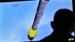 A TV shows a graphic of North Korea's rocket launch at a train station in Seoul in April