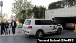 UN vehicles carrying the fact-finding team of the Organization for the Prohibition of Chemical Weapons arrive at the Four Seasons hotel in Damascus on April 14.