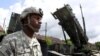 Poland -- A soldier stands next to a Patriot surface-to-air missile battery at an army base in Morag, 26May2010