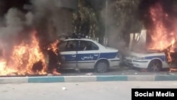 Protesters in Shiraz set police cars on fire, November 16, 2019.