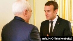 A photo from the Iranian Foreign Ministry showing French President Emmanuel Macron (right) meeting with Iran's foreign minister Mohammad Javad Zarif in Paris. 