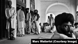 Outside the front door of the late tribal leader Nawab Akbar Khan Bugti's home, several Bugti tribesmen stand guard, while others wait for an audience with their chieftain (file photo).