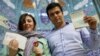 Iran -- An Iranian couple holds documents after voting during presidential elections at a polling station in Tehran, Iran June 18, 2021. Majid Asgaripour/WANA (West Asia News Agency) via REUTERS ATTENTION EDITORS - THIS IMAGE HAS BEEN SUPPLIED BY A THIRD 