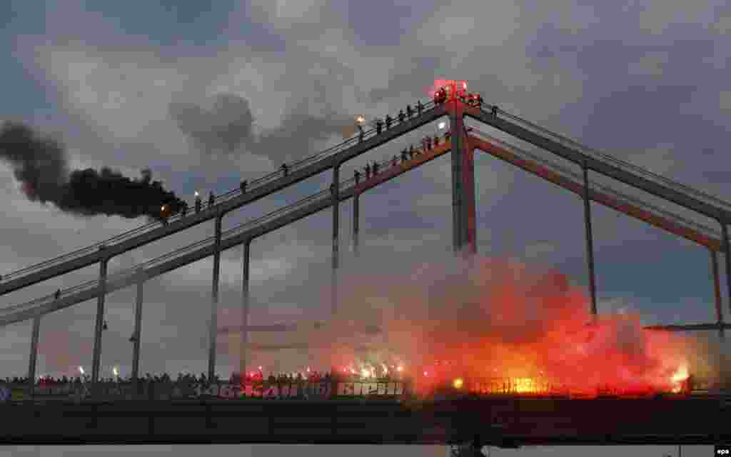 Soccer fans light flares on a bridge across the Dnieper River in Kyiv, Ukraine. (epa/Iren Moroz)