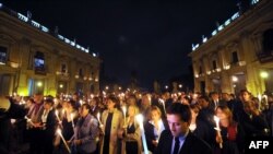 Peope light candles in memory of the victims of Lampedusa on October 4 in Rome, a day after a boat with migrants sank killing more than a hundred people. 