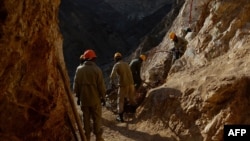 Afghan miners work at a gold mine on a mountainside near the village of Qara Zaghan in Baghlan Province.