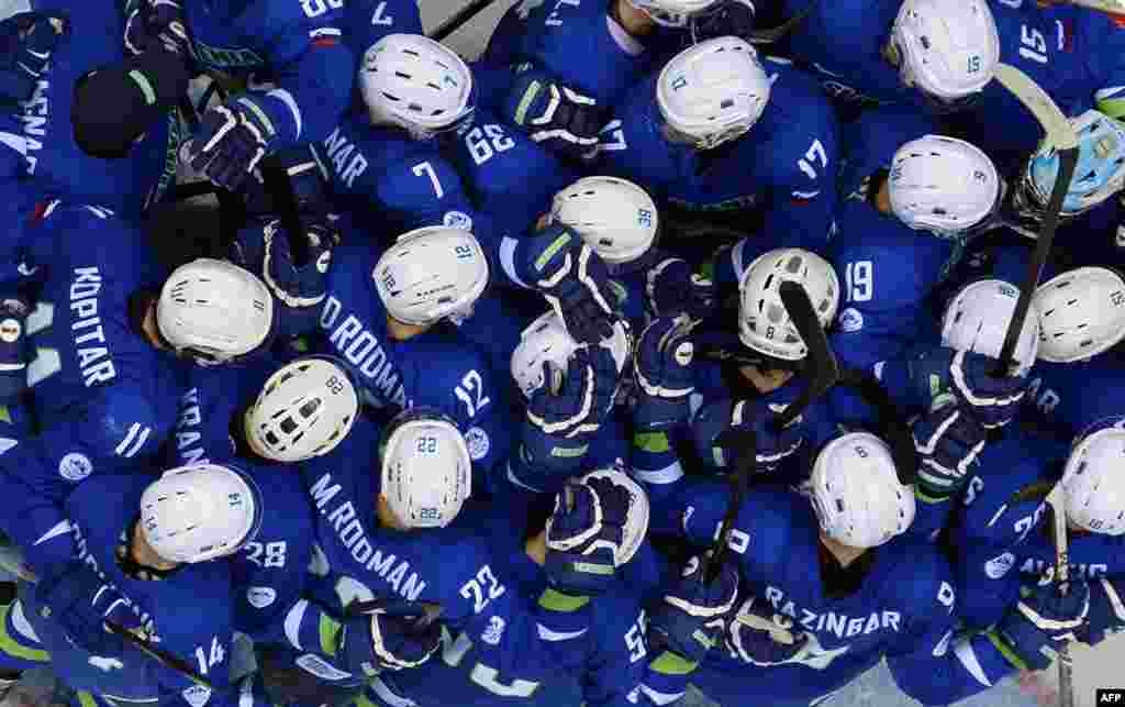 Slovenia's players celebrate at the end of the men's Ice Hockey Group A match after defeating Slovakia by a score of 3:1. (AFP/Alexander Nemenov)
