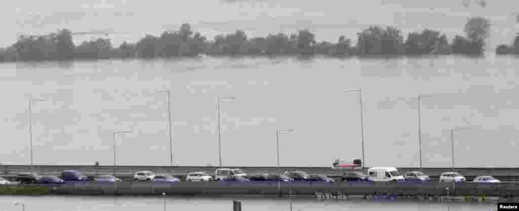 Cars wait on a highway over the flooded Berounka River on the outskirts of Prague.
