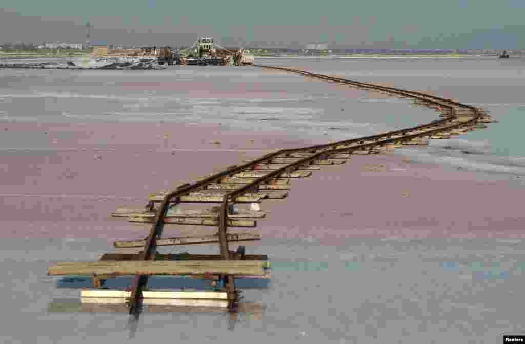 Rails lay across the bed of a drained area of the&nbsp;Sasyk-Sivash&nbsp; lake used for the production of salt&nbsp;near the city of Yevpatoria in Crimea.&nbsp;(Reuters/Pavel Rebrov) 