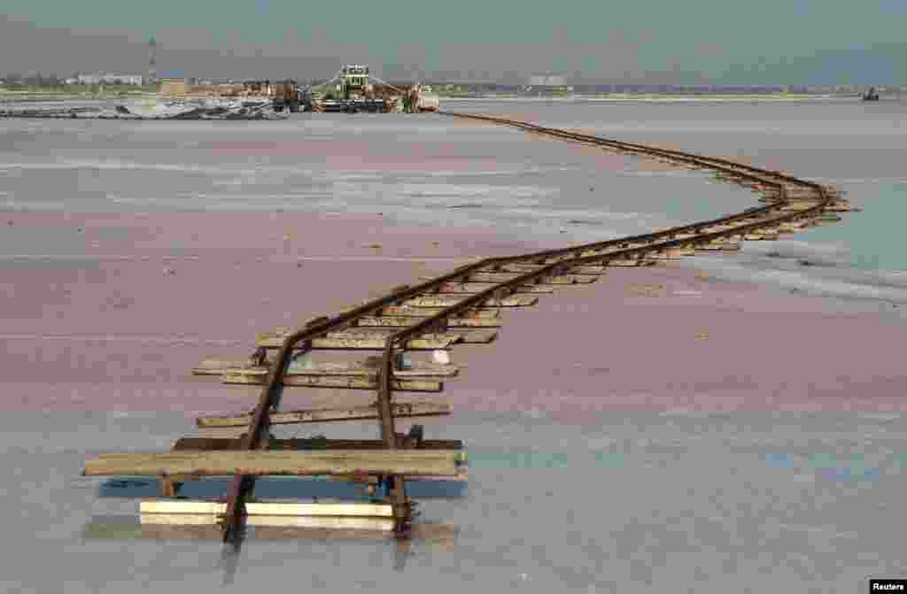 Rails lay across the bed of a drained area of the Sasyk-Sivash lake used for the production of salt near the city of Yevpatoria in Crimea. (Reuters/Pavel Rebrov)