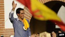 Spanish Alberto Contador waves from a car as he rides through his home village of Pinto, near Madrid, after the apparent Tour de France win in 2010.