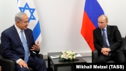 Israeli Prime Minister Benjamin Netanyahu (left) meets with Russian President Vladimir in Moscow on January 29.