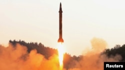 A North Korean ballistic missile is test-fired in an image released in May.