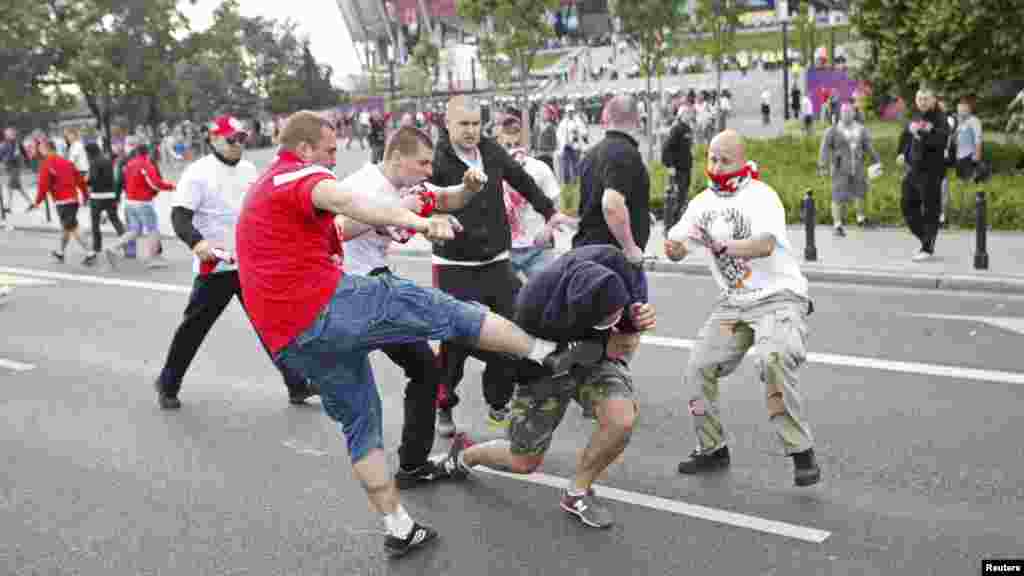 Polish and Russian soccer fans clash outside the National Stadium in Warsaw.