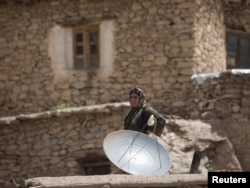 A satellite dish on a rooftop in Iran's Kurdistan Province