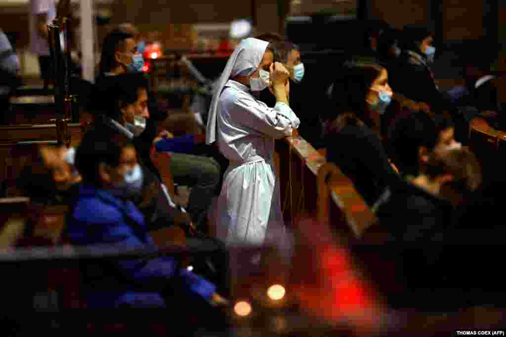 A nun prays at the Sacre-Coeur Basilica in Paris.