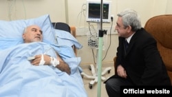 Armenian President Serzh Sarkisian visits wounded opposition presidential candidate Paruyr Hairikian at a Yerevan hospital.