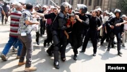 Police detain a supporter of ousted President Muhammad Morsi during clashes in central Cairo on August 13.