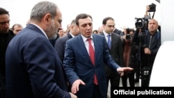 Armenia - Businessman Davit Ghazarian (C) shows Prime Minister Nikol Pashinian around a newly built dairy factory of his Spayka company, Yerevan, March 26, 2019.