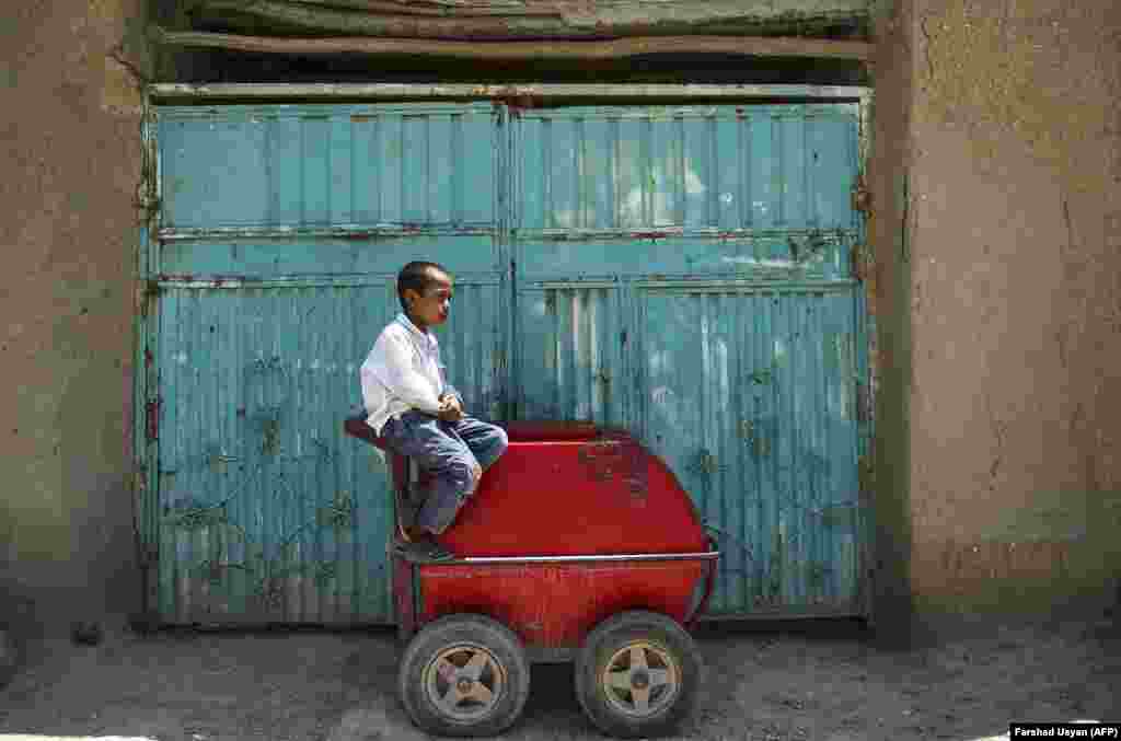 A child laborer looks on as he sells ice cream alongside a street in Mazar-e Sharif, Afghanistan. (AFP/Farshad Usyan)