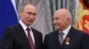 Russian President Vladimir Putin (left) speaks with former Moscow Mayor Yury Luzhkov after awarding him during a ceremony at the Kremlin in Moscow in September 2016.