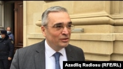 Ilqar Mammadov speaks to reporters on April 23 in Baku.