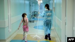 A mother and daughter walk through a hallway at the Russian Children's Clinical Hospital in Moscow. (file photo)