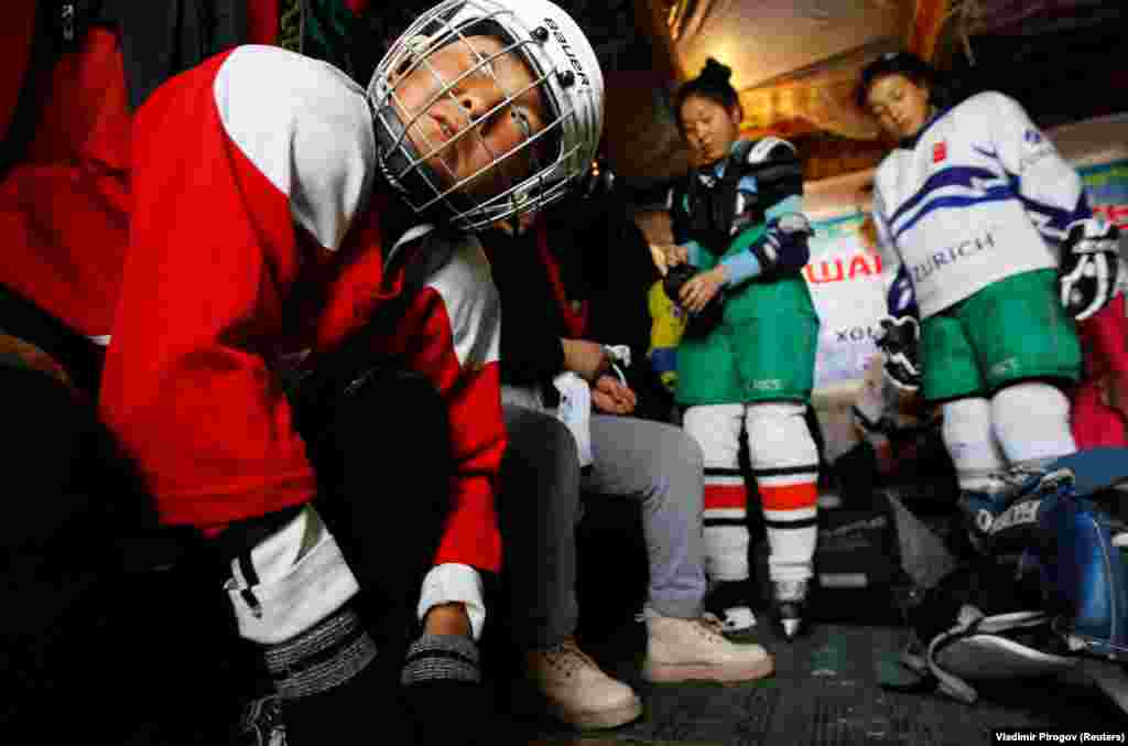 KYRGYZSTAN -- Members of Kyrgyz first female hockey team prepare in a dressing room before a training session in the village of Otradnoye, February 4, 2020