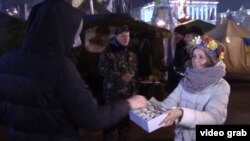 Sofia Marchenko hands out cookies in Kyiv.