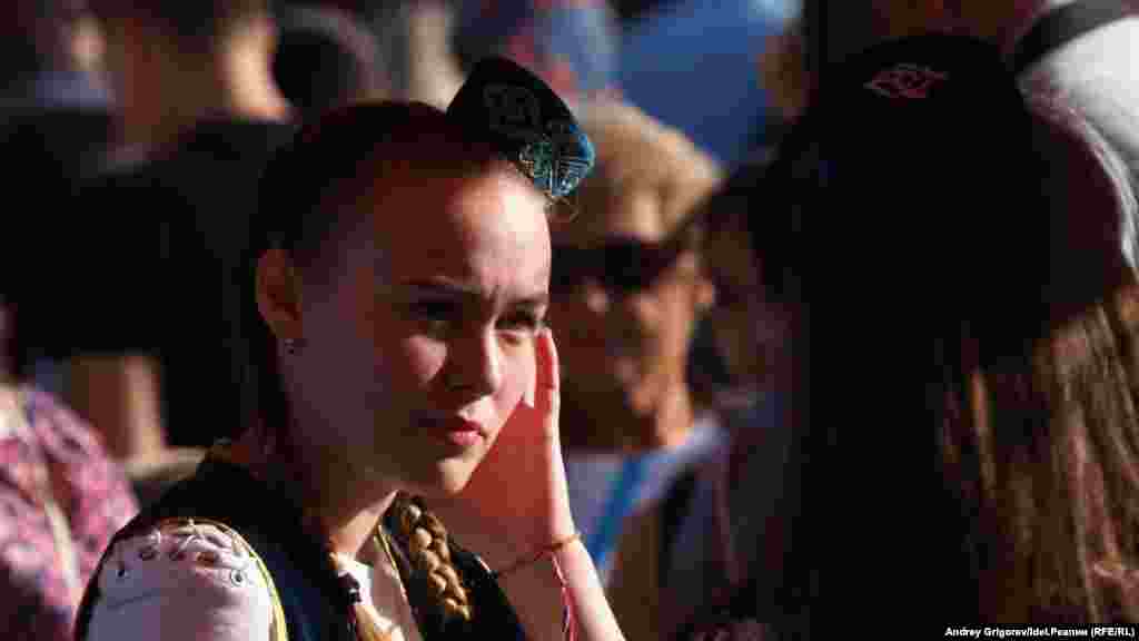 A young woman in traditional Tatar clothing is seen at the market during the celebrations.