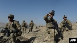 U.S. soldiers stand guard near the site of a suicide attack in Maidan Shar, the capital city of Afghanistan's Wardak Province, in September.