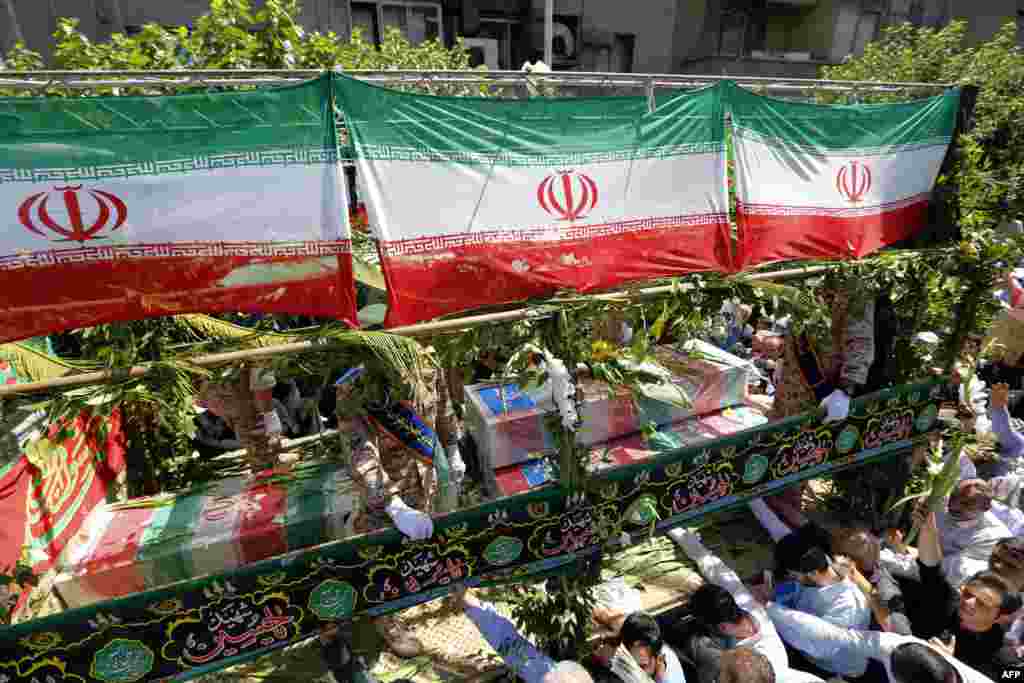 Iranians march during a funeral for victims of deadly attacks on the country's parliament complex and the shrine of revolutionary leader Ayatollah Ruhollah Khomeini, in the capital Tehran on June 9. (AFP/Atta Kenare)