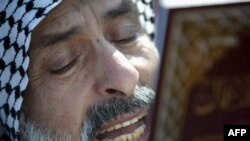 A Shi'ite Muslim man prays during Eid in the Iraqi holy city of Karbala