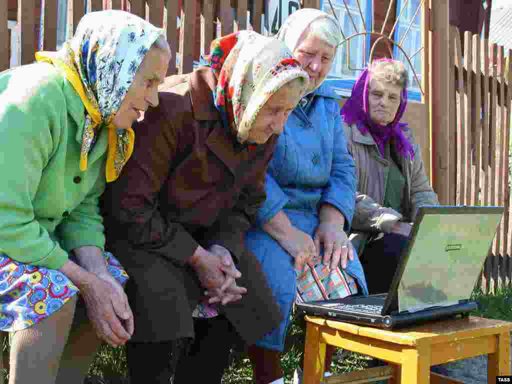 Spread of technology in Russian rural areas - Old women look at a notebook computer in a village in Russia , 6 May 2008