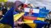 Изображение президента России Владимира Путина на плакате во время одной из акций протеста против масштабного российского вторжения в Украину