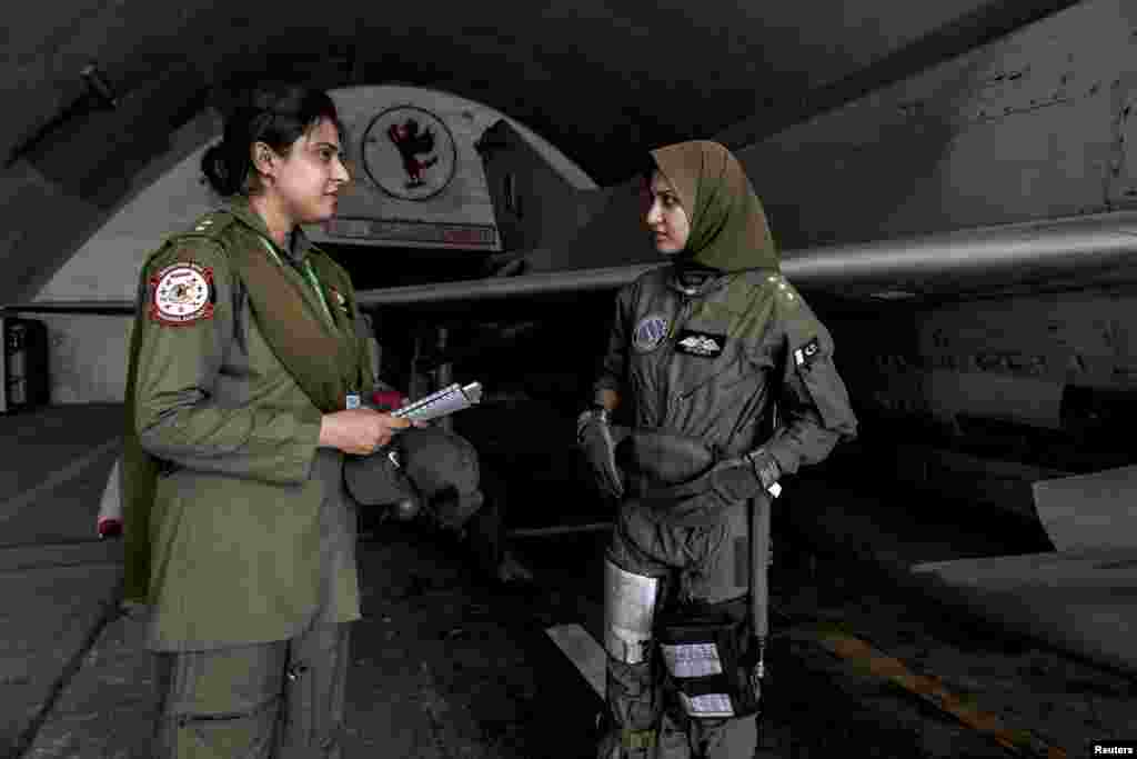 Ayesha Farooqtalks with avionics engineer Anam Hassan at Mushaf base in Sargodha