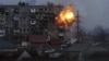 A Russian Army tank shell strikes an apartment building in Mariupol on March 11. The Ukrainian government has said at least 2,300 people have been killed in the besieged Azov Sea port city alone.