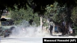 A special-forces soldier fires his weapon during a clash between insurgents and security forces in Kabul on August 16.