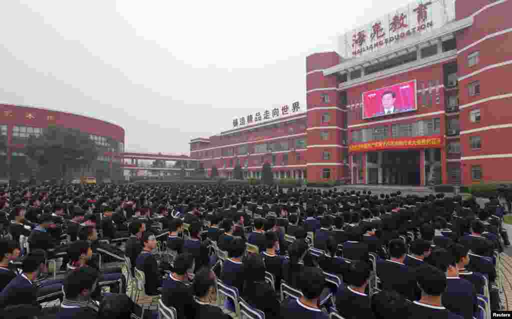 High school students in Zhuji, Zhejiang Province, watch a screen showing Chinese President Hu Jintao delivering the keynote address at the 18th National Congress of the ruling Communist Party in Beijing. (Reuters/China Daily)